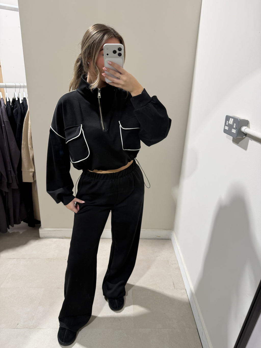 Black half-zip loungewear top with white-piped pockets