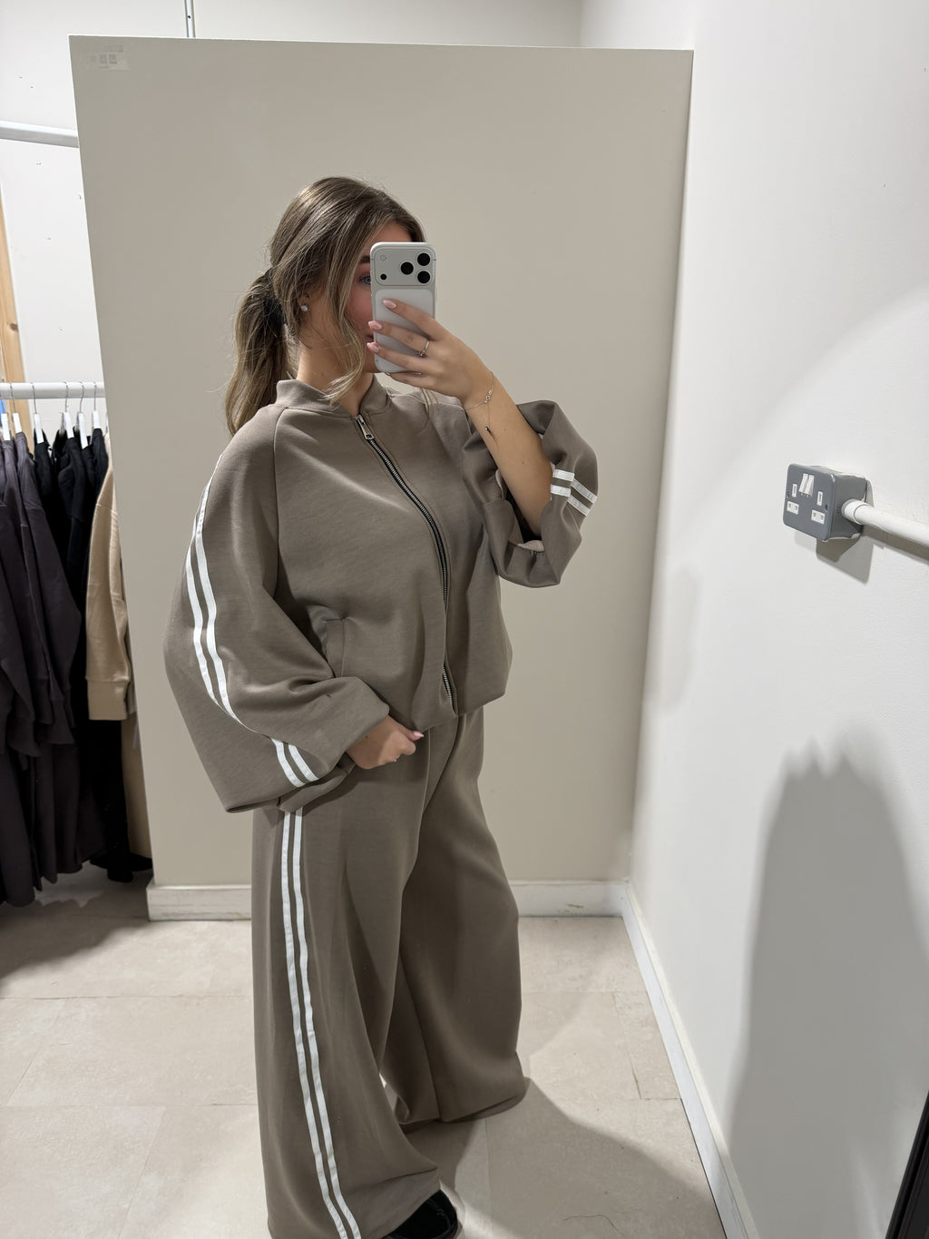 Taupe zip-front top and wide-leg striped trousers side view
