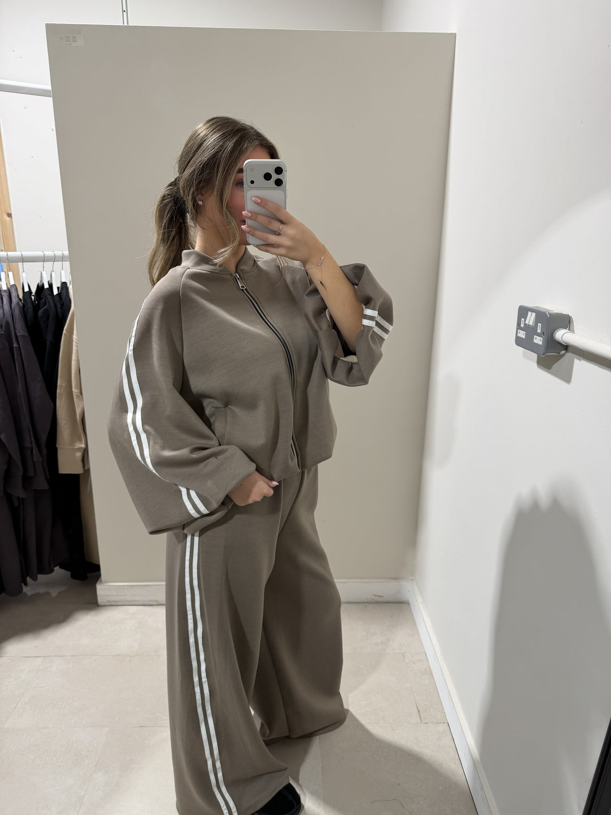 Taupe zip-front top and wide-leg striped trousers side view