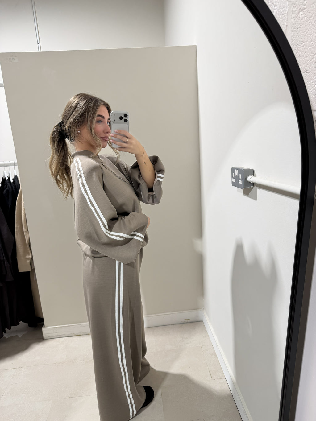 Taupe two-piece outfit showing white sleeve and trouser stripes